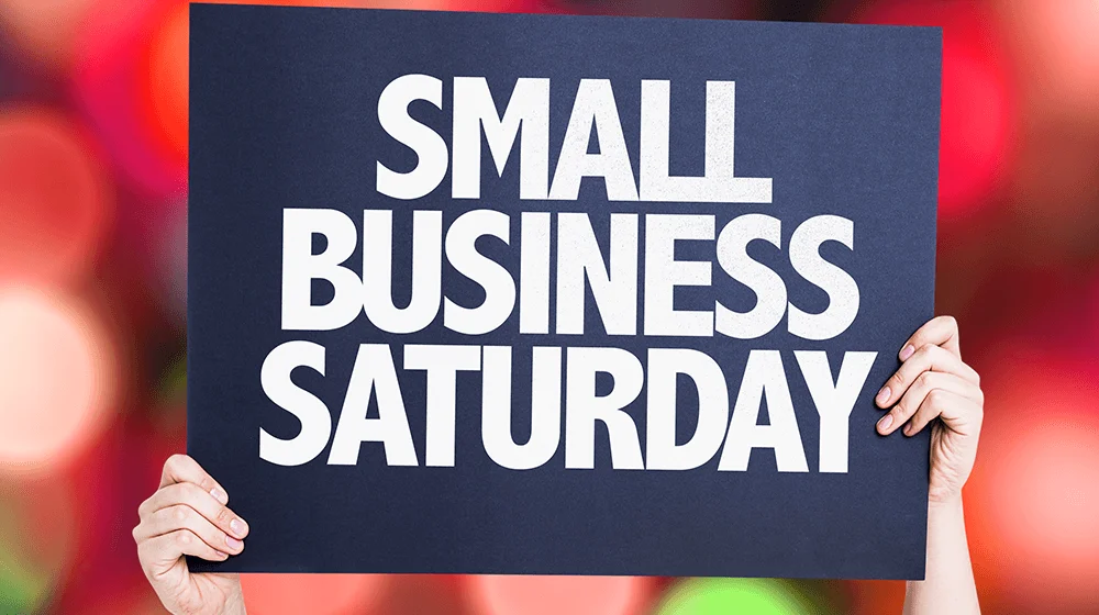 Hands holding a Small Business Saturday sign